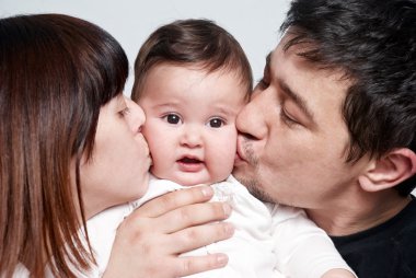 Baby with parents on a white background clipart