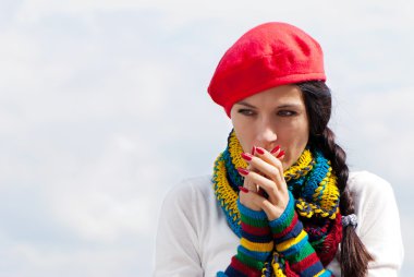 The girl in a red beret against the sky clipart