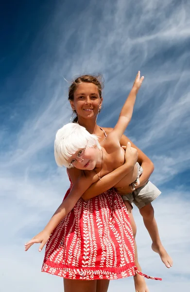 Mother and son on a background of sky — Stock Photo, Image