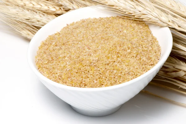 Ground wheat and ears on a light background — Stock Photo, Image