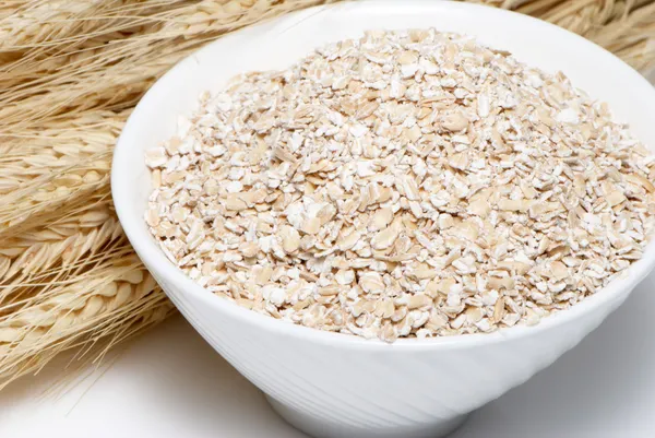 Porridge and Wheat ears on a white background — Stock Photo, Image