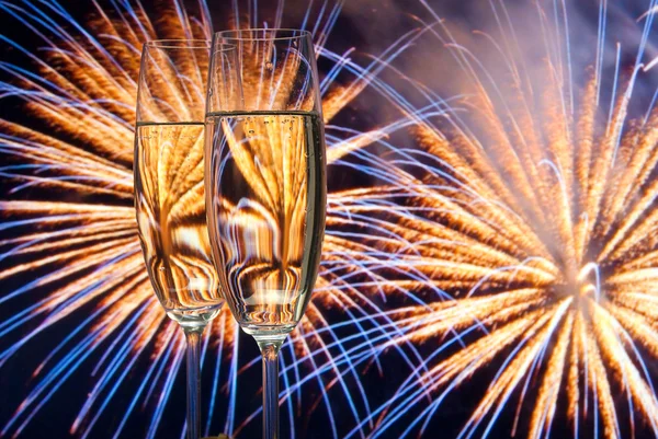 stock image Glasses with champagne against fireworks