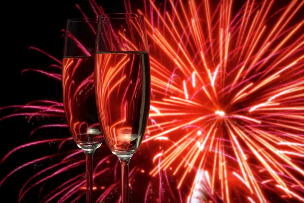 stock image Glasses with champagne against fireworks