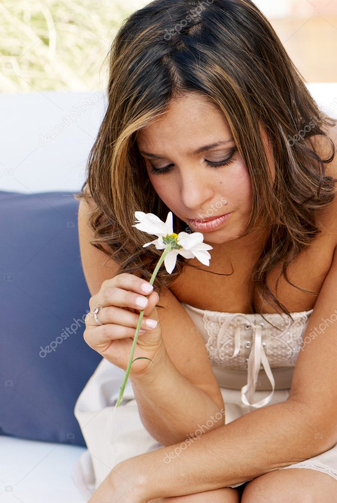 Portrait of the lonely girl with a flower