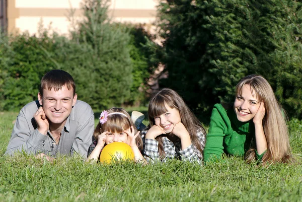 Pais e filhas felizes no parque — Fotografia de Stock