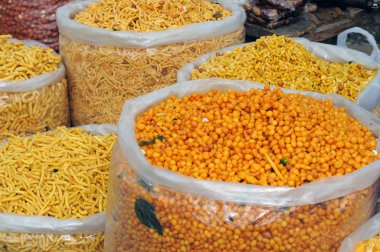 Variety of Indian snacks at a local bazaar clipart