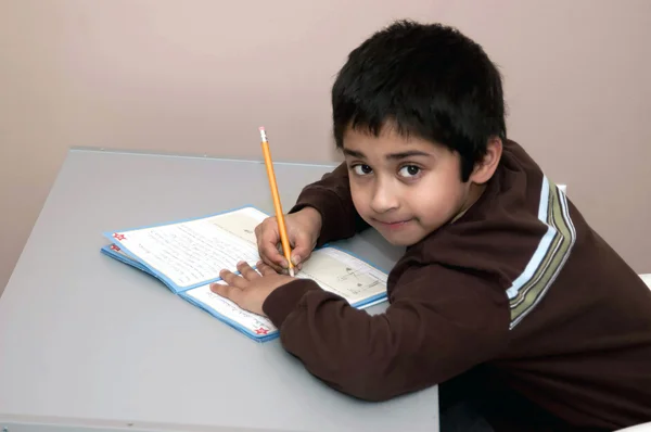 英俊的印度小孩写他的家庭作业 — 图库照片