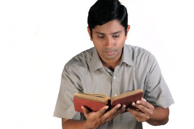 An handsome middle aged man reading an old book clipart