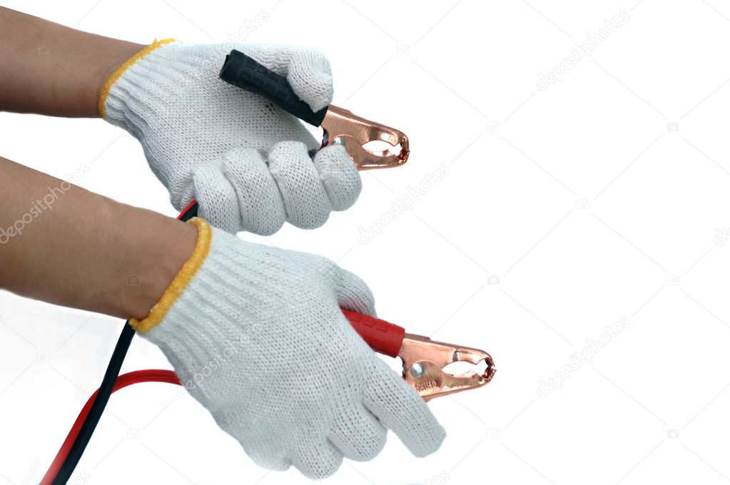 Hands and gloves with car jump start cables