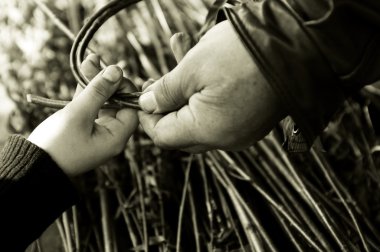 Man teaching child making a wicker basket clipart