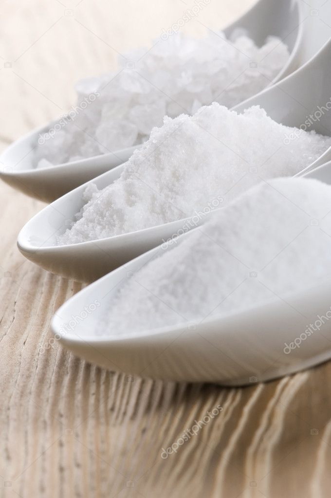 Three spoons with different salt