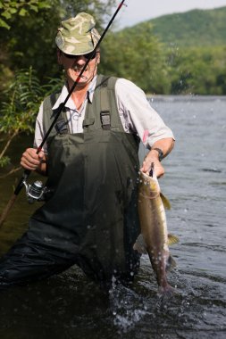 Fisherman catches of salmon clipart