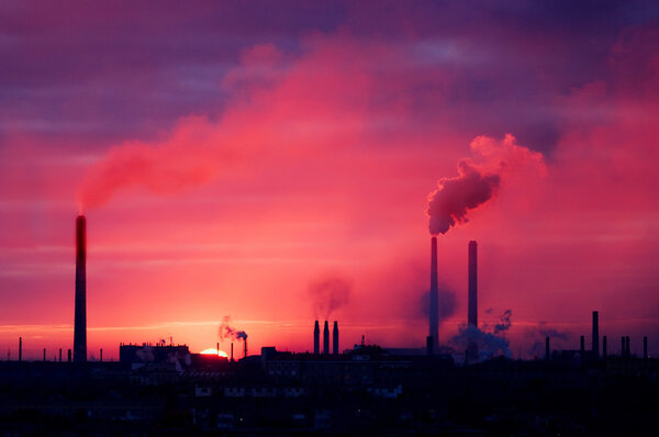 Factory silhouette on a rising sun