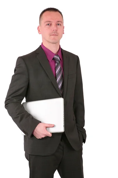 Joven hombre de negocios sosteniendo un portátil — Foto de Stock
