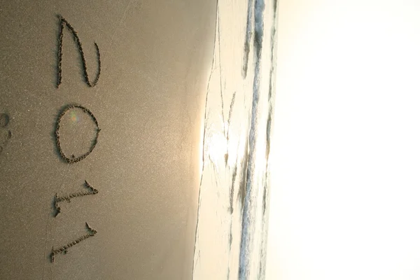 2011 jaar tekst op strand — Stockfoto