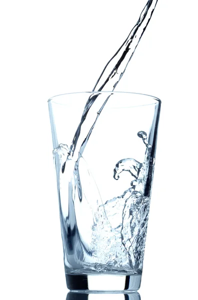 Pouring water into glass isolated on white background — Stock Photo, Image
