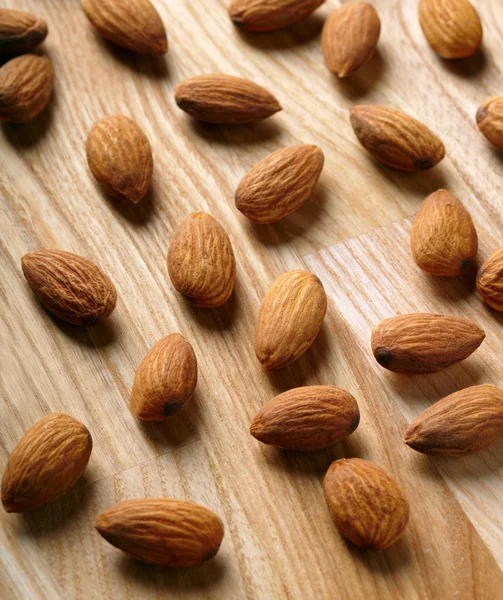 Almonds on wooden background — Stock Photo, Image