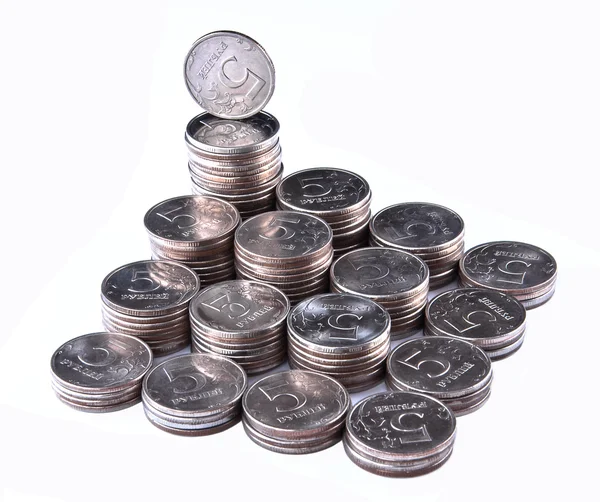 成堆的硬币被隔绝在白色背景上 免版税图库图片