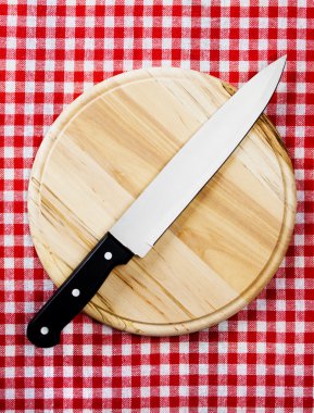 Kitchen knife on wooden board clipart