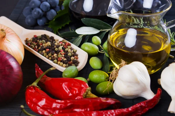 Olive oil with spices and food ingredients — Stock Photo, Image