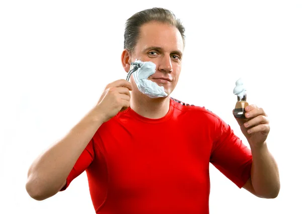 El deportista tiene una afeitada- con la navaja y un cepillo pequeño —  Fotos de Stock