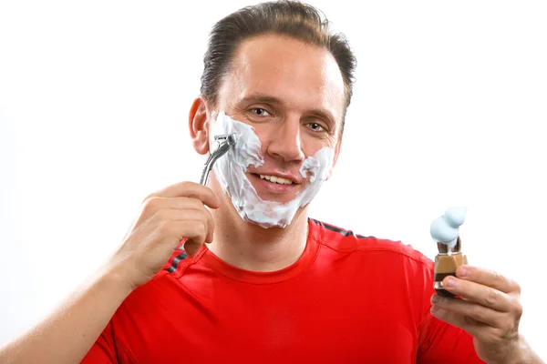 El deportista tiene una afeitada- con la navaja y un cepillo pequeño —  Fotos de Stock