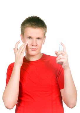 The boy, the teenager with a cream for a problem youthful skin, against spo clipart