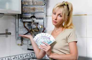 The sad woman the housewife counts up money for repair of a gas water heate clipart