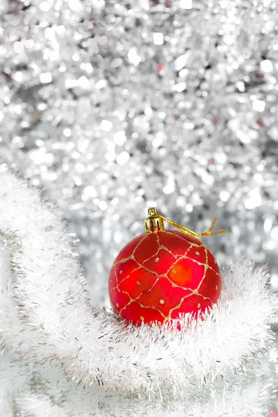 Red New Year's ball on an abstract silvery background — Stock Photo, Image