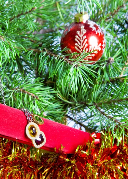 Geschenkdoos met een ketting aan een nieuwjaarsboom — Stockfoto