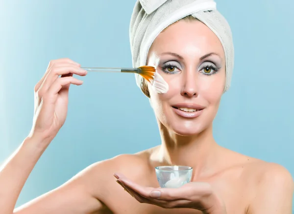 The beautiful young woman with a cosmetic cream — Stock Photo, Image