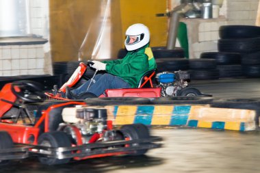 The man at the wheel go-cart racing on training clipart