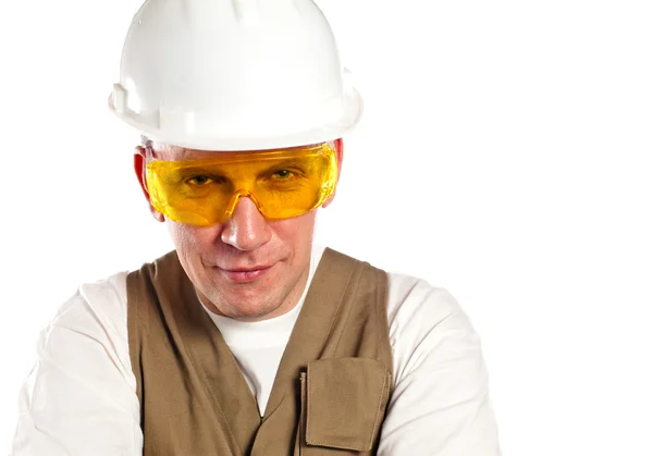 O homem, o construtor, em óculos e um capacete . — Fotografia de Stock