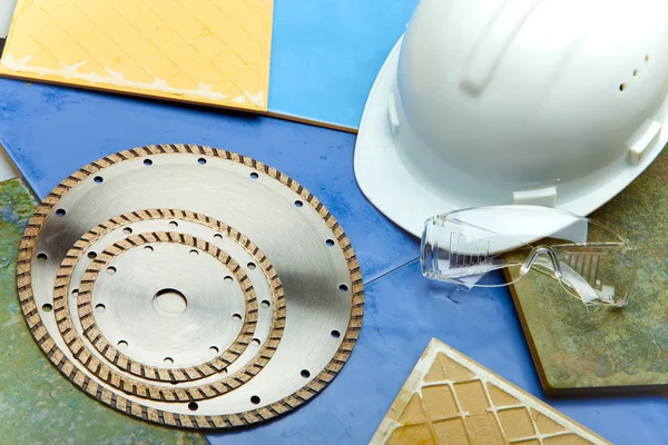 Diamond discs for cutting of tile, goggles and a helmet on a tile — Stock Photo, Image