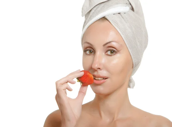 Beautiful young woman in towel with a strawberry, isolated on white backgro — Stock Photo, Image