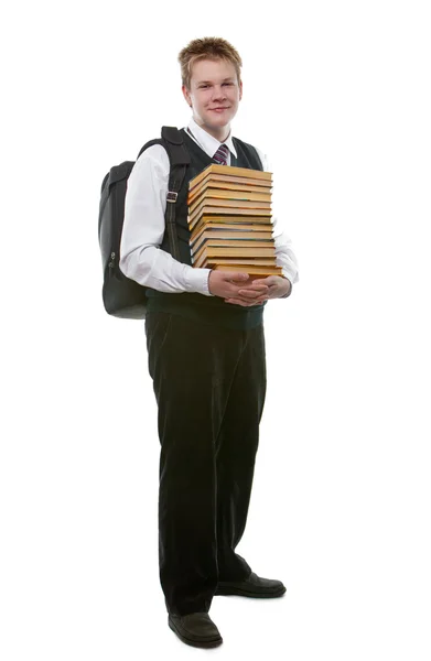 O estudante em um uniforme escolar com um enorme pacote de livros — Fotografia de Stock