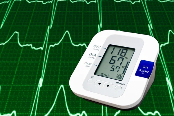 stock image Digital blood pressure monitor with cardiogram in the background