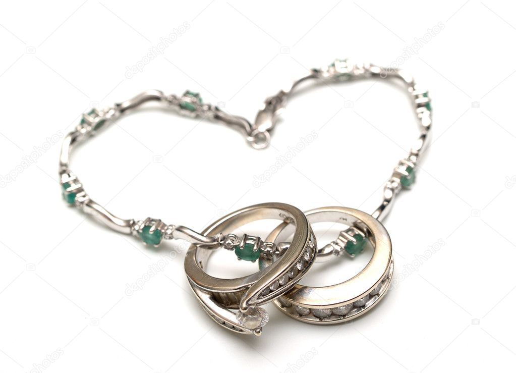Two golden wedding rings with stones with chainlet