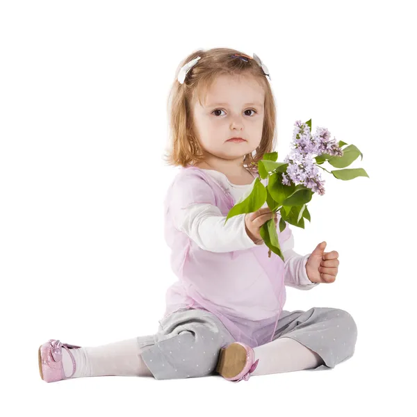 Little girl giving a branch of lilac — Stock Photo, Image