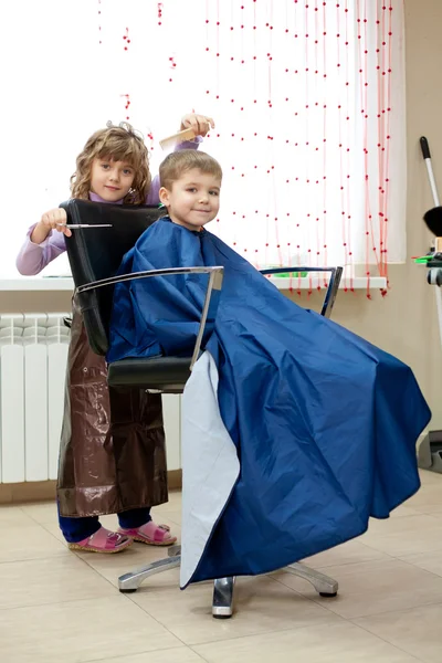 Мальчик и девочка в парикмахерской — стоковое фото