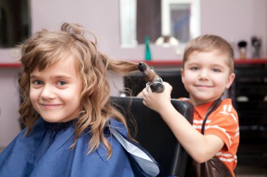 Little funny children play in the barbershop clipart