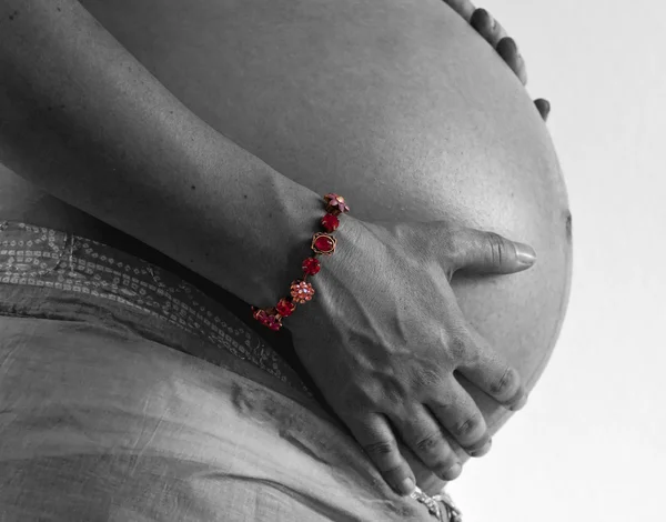 Pregnant woman holding her tummy in black and white — Stock Photo, Image