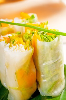 Fresh tipycal vietnamese style summer rolls,on a palm leaf clipart