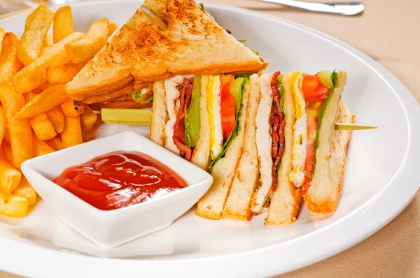 stock image Fresh triple decker club sandwich with french fries on side