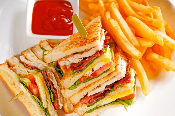 stock image Fresh triple decker club sandwich with french fries on side
