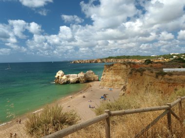 A section of the idyllic Praia de Rocha beach clipart