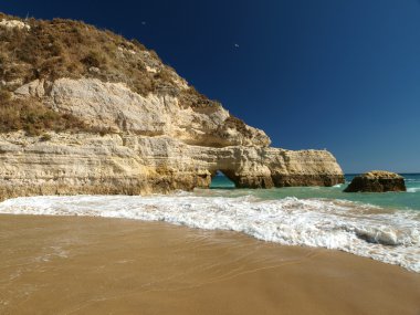 A section of the idyllic Praia de Rocha beach clipart