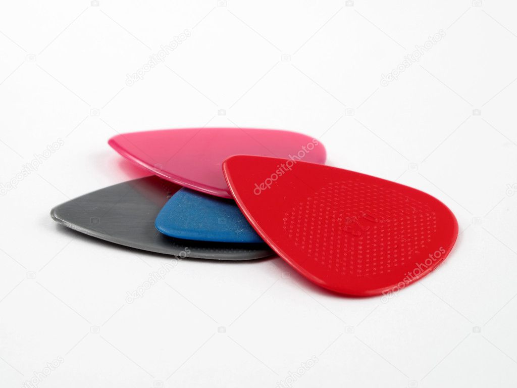 Closeup of 4 colourful plectrums isolated on white #5