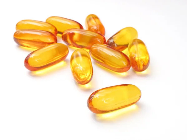 Yellow pills on the white background — Stock Photo, Image