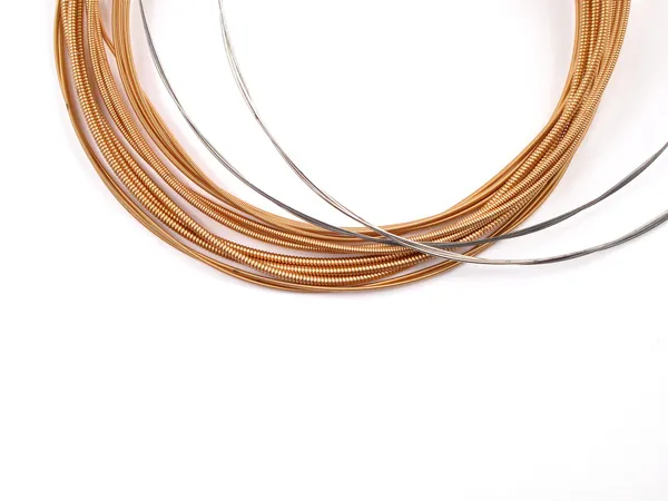 A set of acoustic guitar strings on white background Royalty Free Stock Images